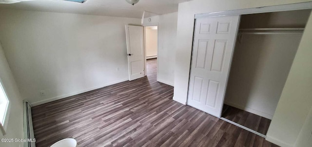 18 Railroad Ave, Berlin, NY 12022 - unfurnished bedroom with dark wood-style floors, a closet, and a baseboard radiator