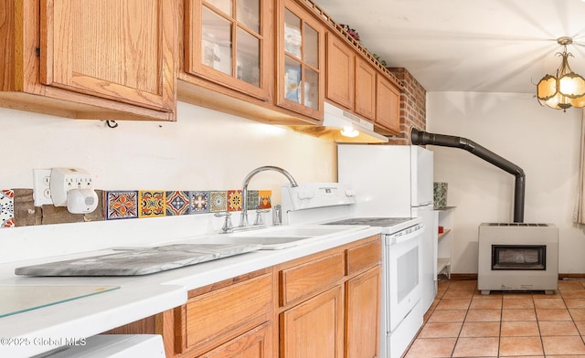 143 Main St, Maryland, NY 12155 - kitchen featuring heating unit, a wood stove, light countertops, electric stove, and under cabinet range hood