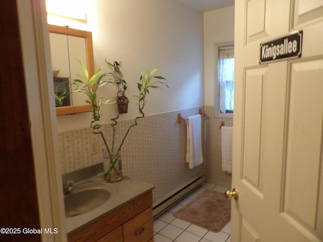 143 Main St, Maryland, NY 12155 - half bath with a baseboard radiator, vanity, a wainscoted wall, and tile patterned floors