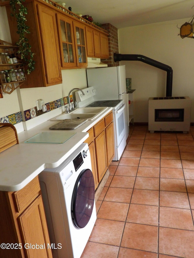 143 Main St, Maryland, NY 12155 - kitchen featuring washer / clothes dryer, brown cabinetry, a wood stove, white electric range oven, and light tile patterned floors