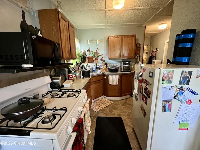 143 Marriott Ave, Schenectady, NY 12304 - kitchen featuring white appliances, brown cabinetry, and light countertops