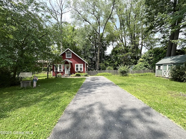 143 Marriott Ave, Schenectady, NY 12304 - bungalow featuring asphalt driveway, an outdoor structure, and view of wooded area