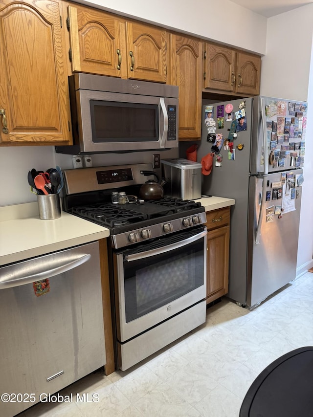 7048 Suzanne Ln, Guilderland, NY 12303 - kitchen featuring appliances with stainless steel finishes, light countertops, and brown cabinetry
