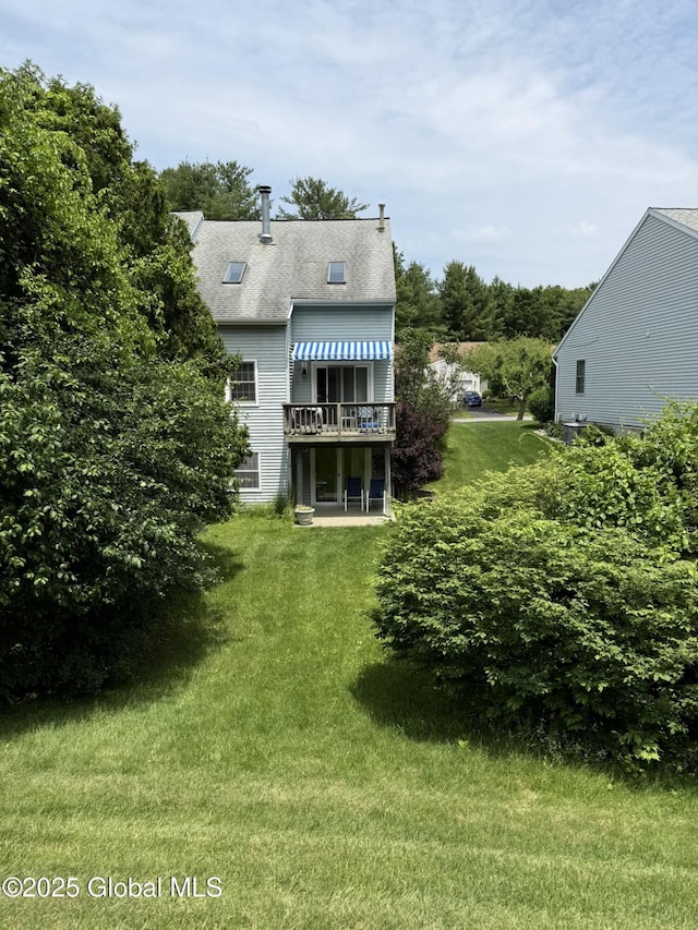 7048 Suzanne Ln, Guilderland, NY 12303 - back of property with a yard and a wooden deck