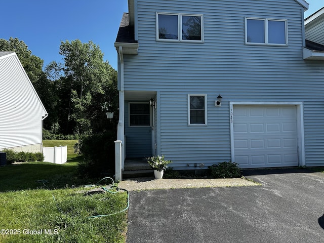 7048 Suzanne Ln, Guilderland, NY 12303 - rear view of property with a garage and driveway