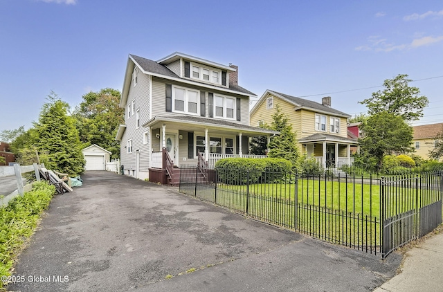 134 Whitehall Rd, Albany, NY 12209 - american foursquare style home with covered porch, an outbuilding, a detached garage, a fenced front yard, and asphalt driveway
