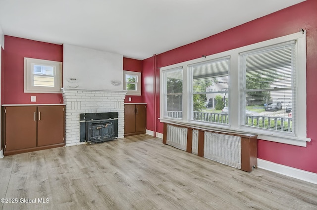134 Whitehall Rd, Albany, NY 12209 - unfurnished living room with wood finished floors and a brick fireplace