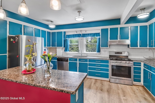 134 Whitehall Rd, Albany, NY 12209 - kitchen with stainless steel appliances, under cabinet range hood, tasteful backsplash, blue cabinets, and light wood-type flooring