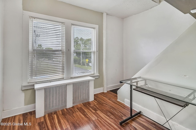 134 Whitehall Rd, Albany, NY 12209 - stairway featuring radiator and wood finished floors