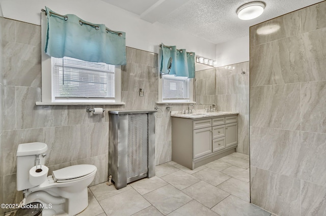 134 Whitehall Rd, Albany, NY 12209 - full bath featuring tile walls, vanity, tile patterned floors, tiled shower, and a textured ceiling