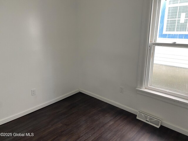 629 Lang St, Schenectady, NY 12308 - spare room featuring baseboards and dark wood-type flooring