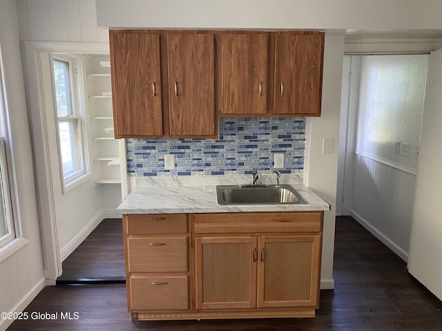 629 Lang St, Schenectady, NY 12308 - kitchen with dark wood-style flooring, tasteful backsplash, light countertops, and brown cabinetry