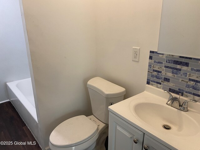 629 Lang St, Schenectady, NY 12308 - bathroom featuring vanity, a bath, backsplash, and wood finished floors