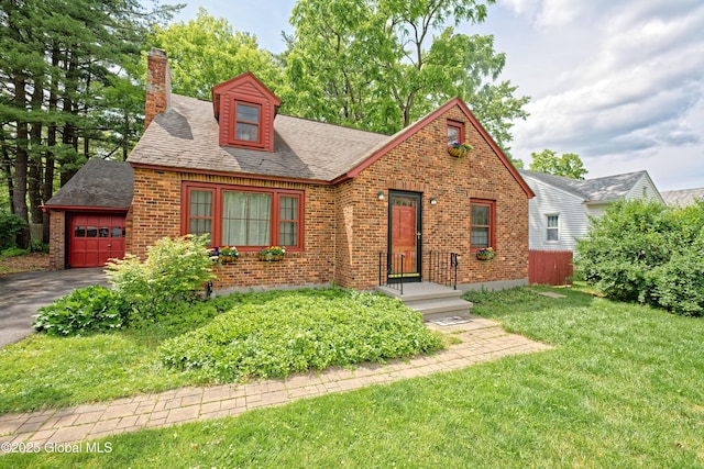 2305 Balltown Rd, Niskayuna, NY 12309 - english style home featuring a chimney, brick siding, a front yard, an attached garage, and asphalt driveway