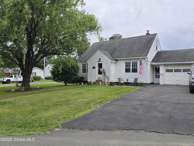 2922 Halsey Dr, Schenectady, NY 12304 - cape cod house with an attached garage, asphalt driveway, a chimney, a front lawn, and a shingled roof