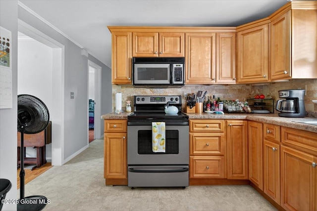 303 E Washington Ave, Rensselaer, NY 12144 - kitchen with appliances with stainless steel finishes, decorative backsplash, light countertops, and ornamental molding