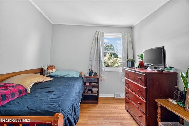 303 E Washington Ave, Rensselaer, NY 12144 - bedroom with crown molding and light wood-type flooring