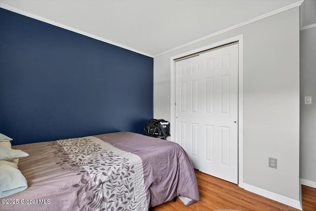 303 E Washington Ave, Rensselaer, NY 12144 - bedroom featuring ornamental molding, wood finished floors, and a closet