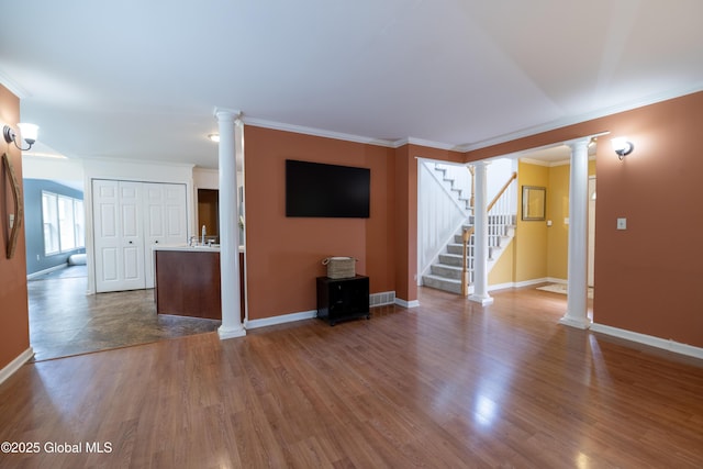 22 Santee Dr, Wilton, NY 12831 - unfurnished living room featuring ornate columns, wood finished floors, stairway, and ornamental molding
