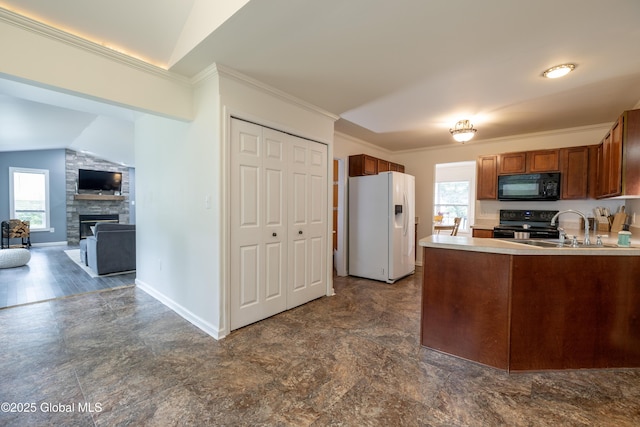 22 Santee Dr, Wilton, NY 12831 - kitchen with black appliances, plenty of natural light, a peninsula, brown cabinetry, and vaulted ceiling