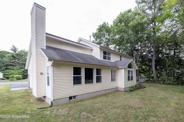 22 Santee Dr, Wilton, NY 12831 - rear view of property featuring a chimney, a lawn, and roof with shingles