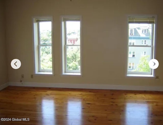 57 Dove St, Albany, NY 12210 - spare room featuring wood finished floors and baseboards