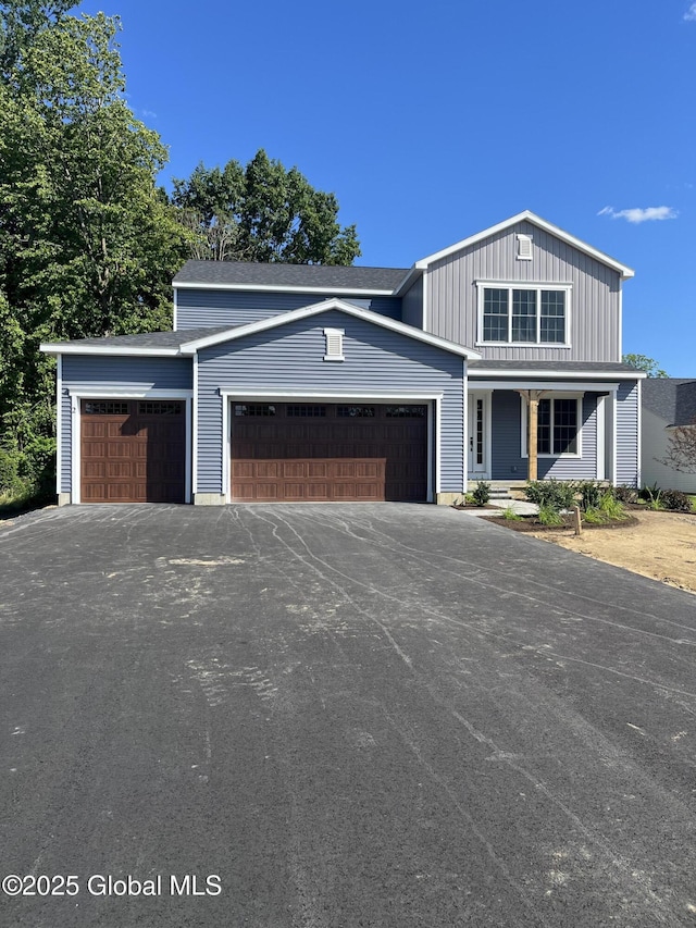 LOT19 Windrow Way, Halfmoon, NY 12118 - view of front of home with covered porch, an attached garage, asphalt driveway, and board and batten siding