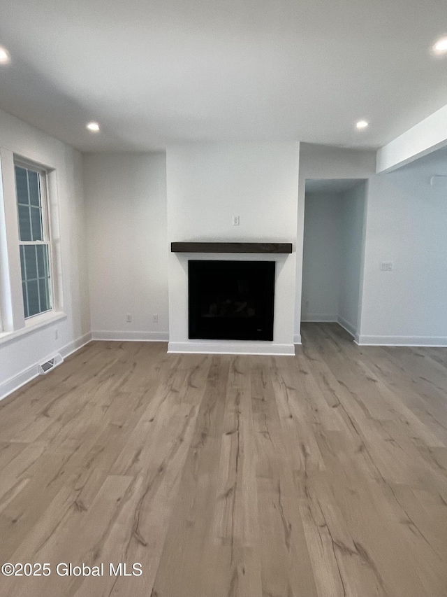 LOT19 Windrow Way, Halfmoon, NY 12118 - unfurnished living room featuring wood finished floors, recessed lighting, and a fireplace