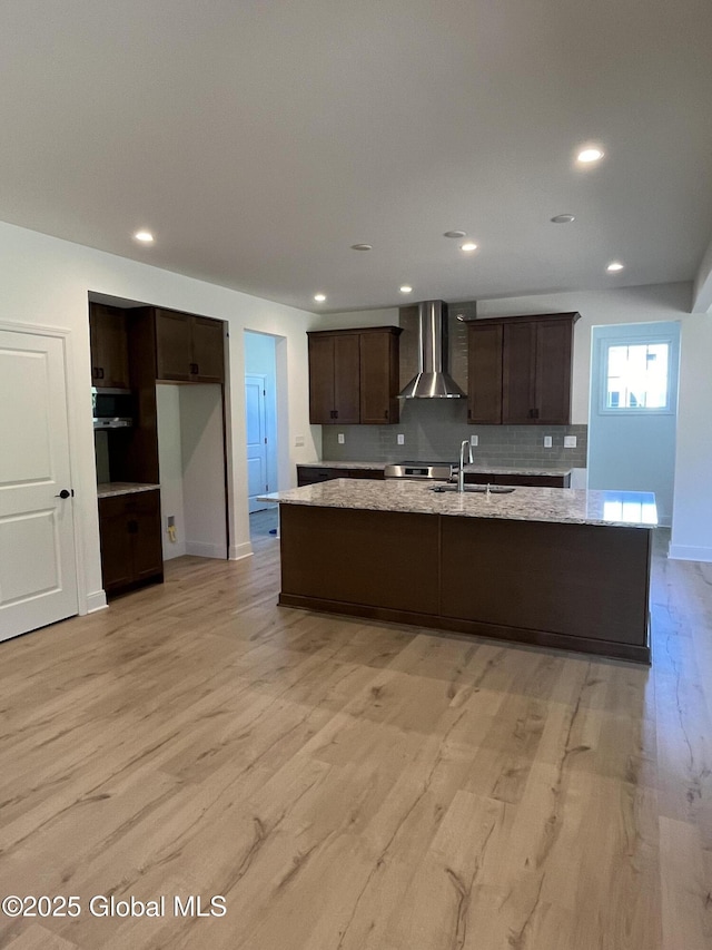 LOT19 Windrow Way, Halfmoon, NY 12118 - kitchen featuring wall chimney exhaust hood, dark brown cabinets, a spacious island, light wood-style flooring, and recessed lighting
