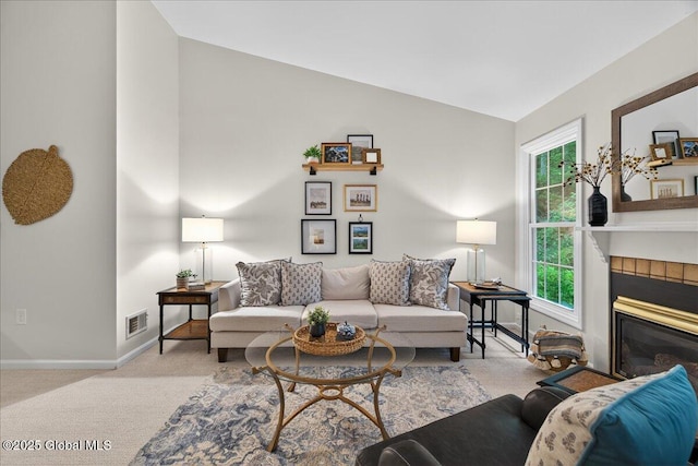 16 Whispering Pines Rd, Wilton, NY 12831 - carpeted living area with lofted ceiling and a tiled fireplace