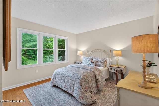 16 Whispering Pines Rd, Wilton, NY 12831 - bedroom featuring wood finished floors and a textured ceiling