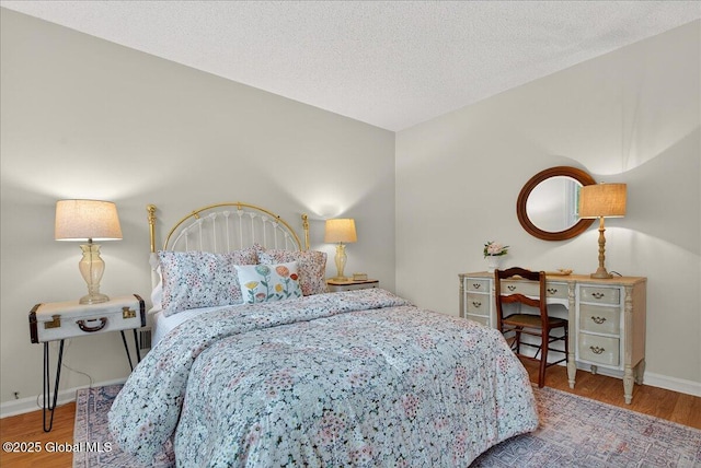 16 Whispering Pines Rd, Wilton, NY 12831 - bedroom with wood finished floors and a textured ceiling