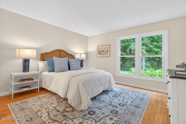 16 Whispering Pines Rd, Wilton, NY 12831 - bedroom with light wood-type flooring and a textured ceiling