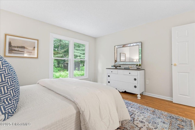 16 Whispering Pines Rd, Wilton, NY 12831 - bedroom with wood finished floors and a textured ceiling
