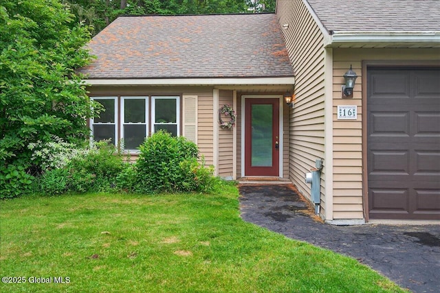 16 Whispering Pines Rd, Wilton, NY 12831 - view of front of property with roof with shingles, a front lawn, and an attached garage