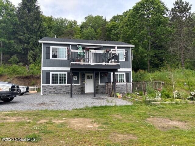 600 State Highway 309, Gloversville, NY 12078 - view of front of house featuring stone siding, a deck, and a view of trees