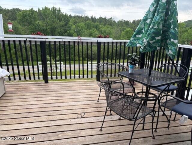 600 State Highway 309, Gloversville, NY 12078 - wooden terrace featuring a view of trees and outdoor dining space