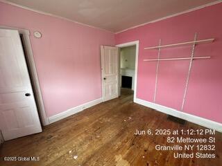 82 Mettowee St, Granville, NY 12832 - unfurnished bedroom featuring wood finished floors and a closet