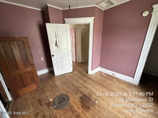 82 Mettowee St, Granville, NY 12832 - unfurnished bedroom with ornamental molding and wood finished floors