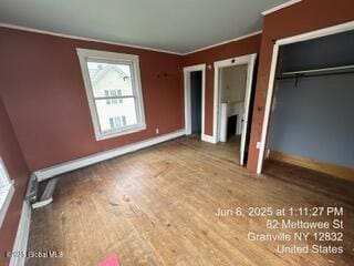 82 Mettowee St, Granville, NY 12832 - unfurnished bedroom featuring crown molding, a closet, and wood finished floors
