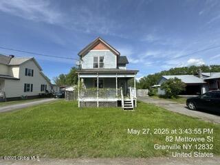 82 Mettowee St, Granville, NY 12832 - view of front of home featuring a porch and a front lawn