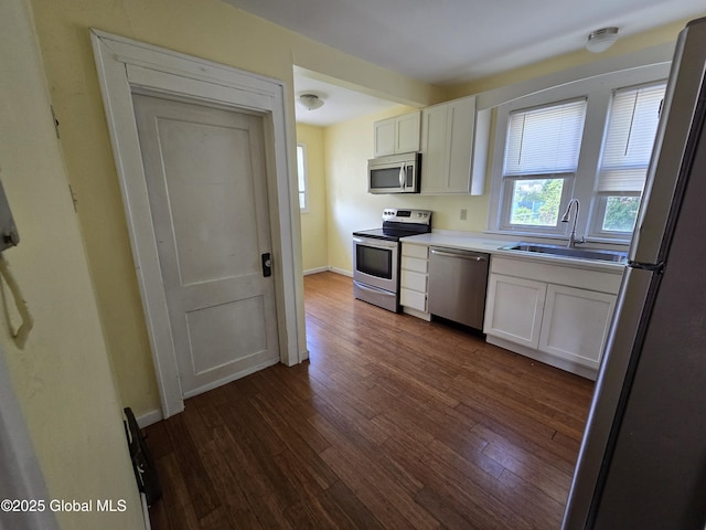 218 Sixteenth St, Schenectady, NY 12306 - kitchen with appliances with stainless steel finishes, white cabinetry, dark wood-style floors, and light countertops