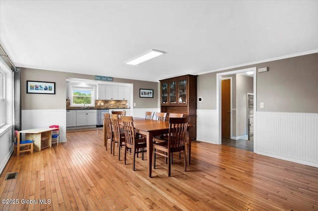 344 Fortsville Rd, Moreau, NY 12831 - dining space featuring wainscoting, light wood finished floors, and crown molding