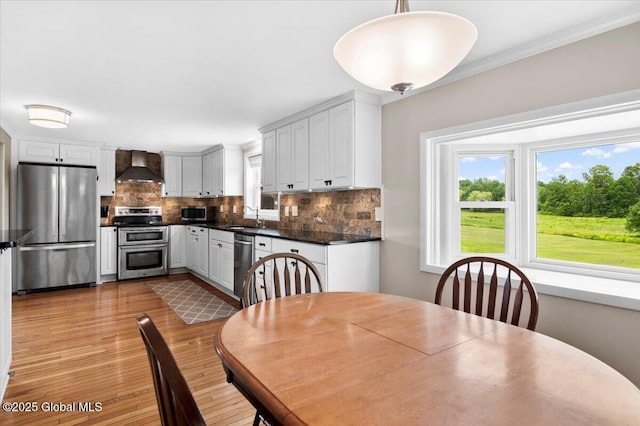 344 Fortsville Rd, Moreau, NY 12831 - dining area with healthy amount of natural light, light wood-style flooring, and crown molding