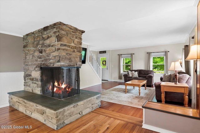 344 Fortsville Rd, Moreau, NY 12831 - living room with hardwood / wood-style floors, stairway, crown molding, and a stone fireplace