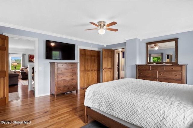 344 Fortsville Rd, Moreau, NY 12831 - bedroom with light wood-type flooring, ornamental molding, a closet, and a ceiling fan