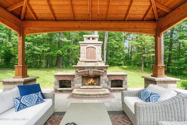 428 Ridgehill Rd, Guilderland, NY 12303 - view of patio with a gazebo, view of wooded area, and an outdoor living space with a fireplace