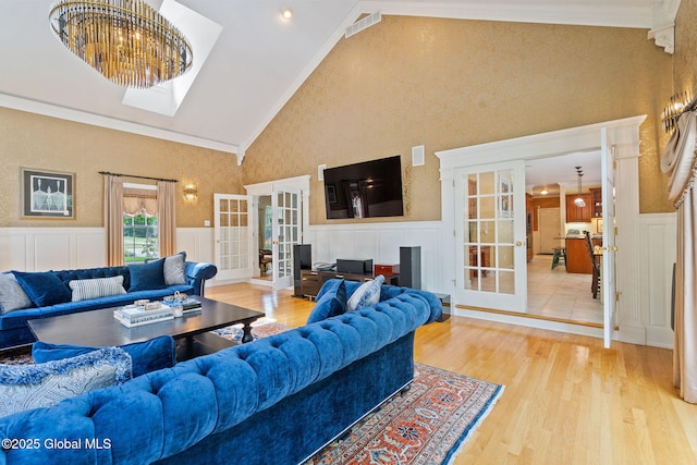 428 Ridgehill Rd, Guilderland, NY 12303 - living area with french doors, ornamental molding, wainscoting, wood finished floors, and a decorative wall