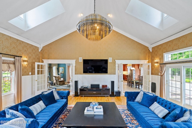 428 Ridgehill Rd, Guilderland, NY 12303 - living area featuring a skylight, vaulted ceiling, crown molding, french doors, and a chandelier