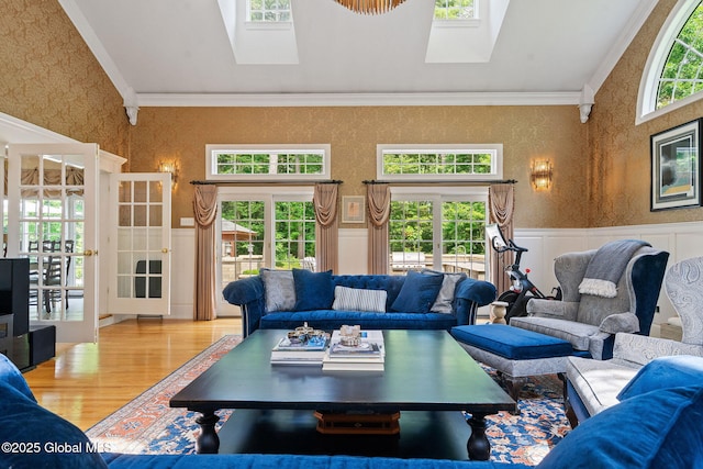 428 Ridgehill Rd, Guilderland, NY 12303 - living room with a skylight, wallpapered walls, wainscoting, crown molding, and wood finished floors